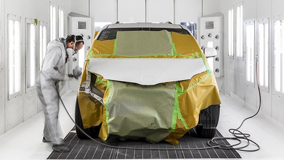 Collision Center Technician Painting a Vehicle | Acton Toyota of Littleton in Littleton MA